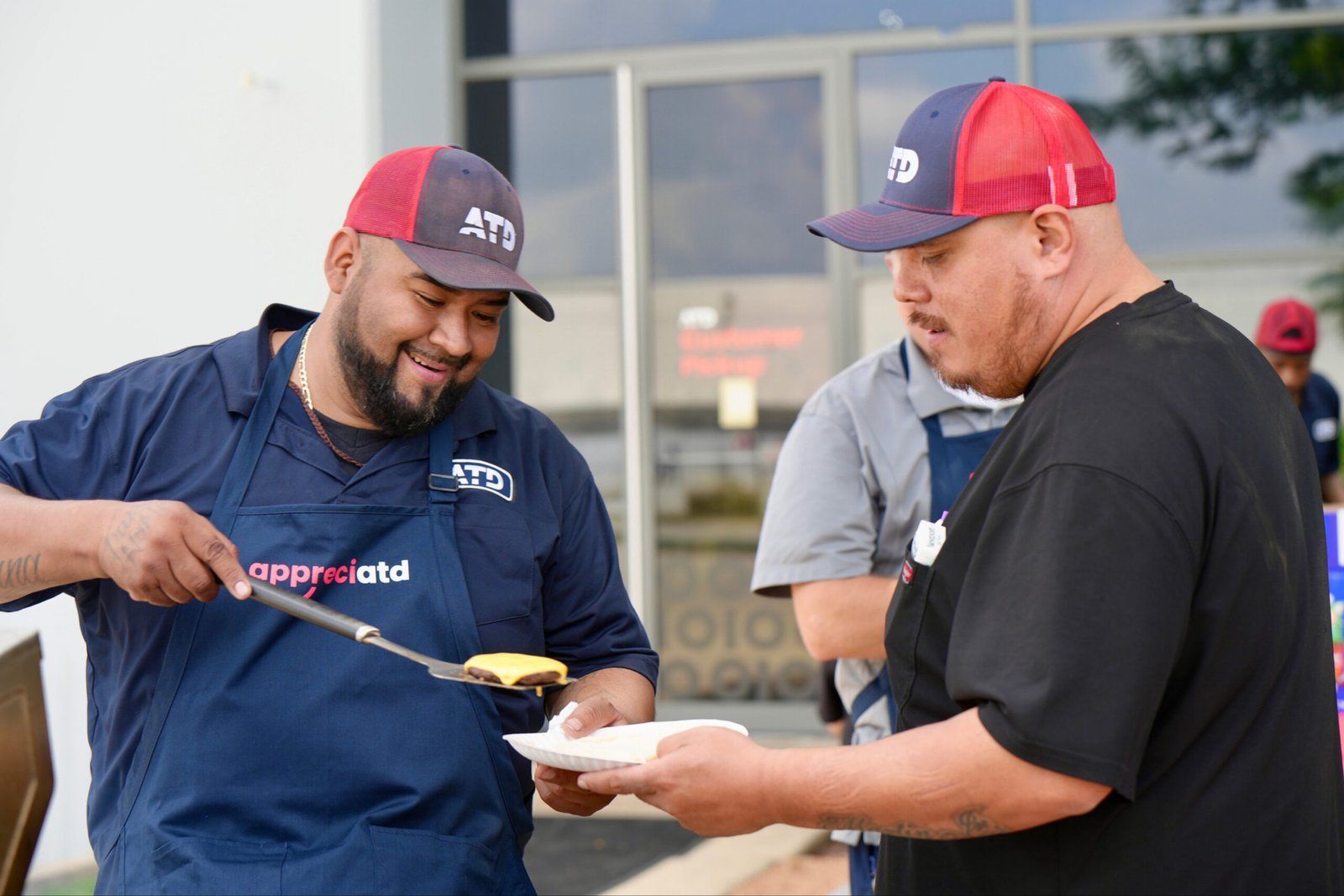 Associates serving food at a team cookout