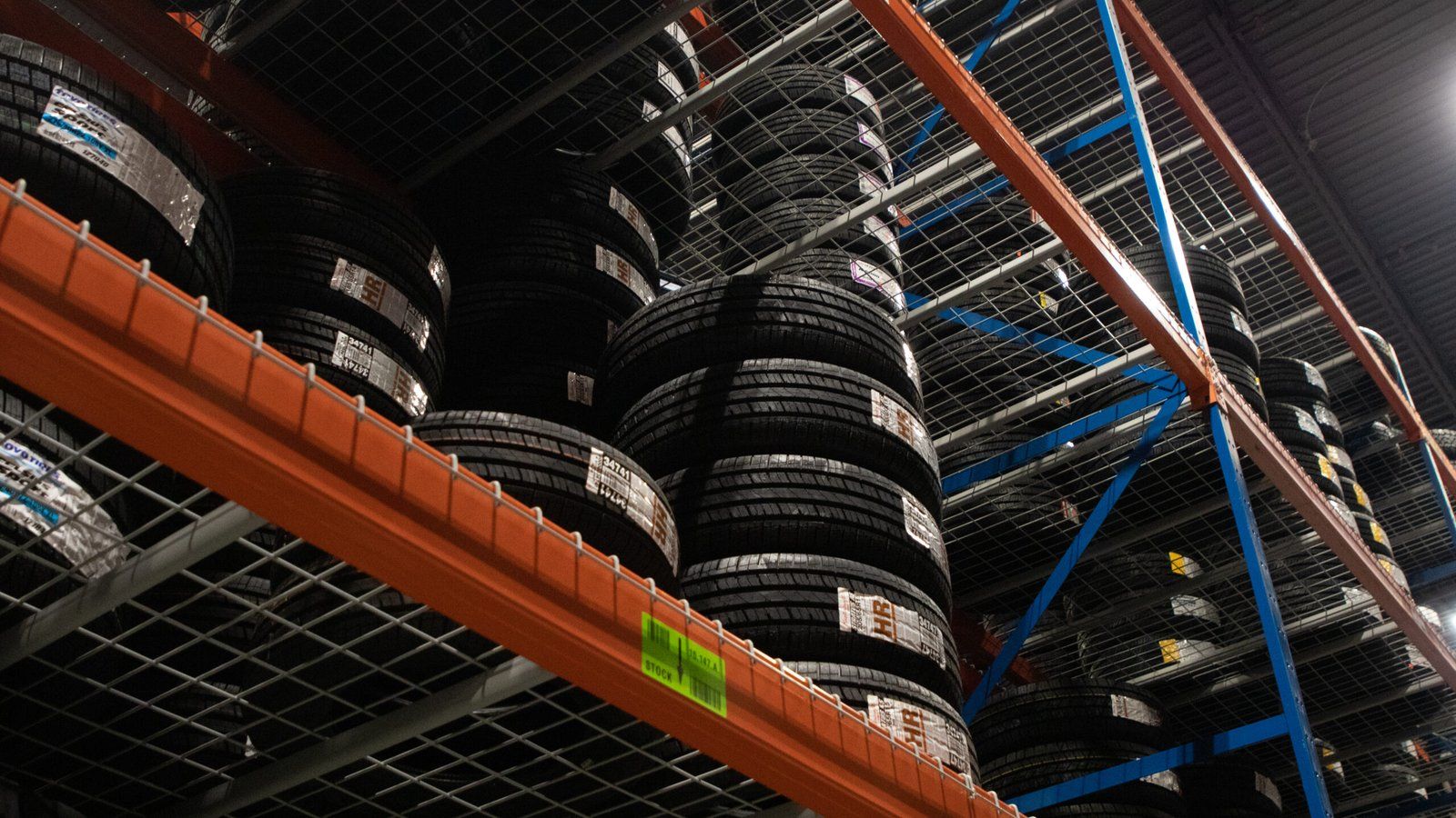 Tires stacked on orange racking